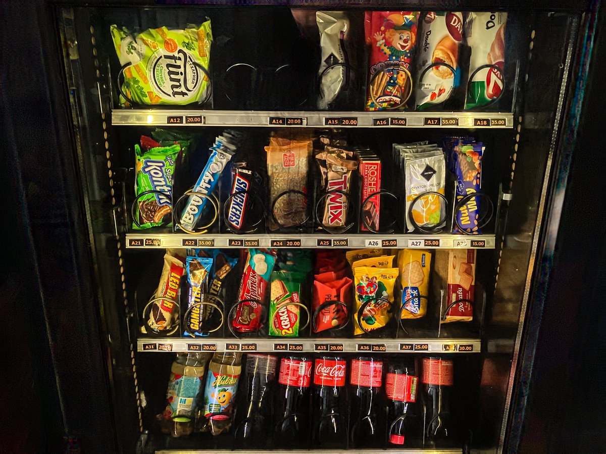 Refrigerated vending machine filled with beverages and snacks